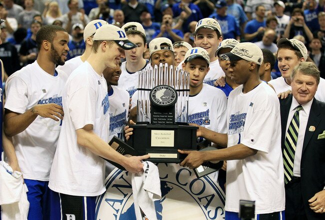 GREENSBORO, NC - MARCH 13:  The Duke Blue Devils celebrate with the ACC Championship Trophy after their 75-58 victory over the North Carolina Tar Heels in the championship game of the 2011 ACC men's basketball tournament at the Greensboro Coliseum on March 13, 2011 in Greensboro, North Carolina.  (Photo by Streeter Lecka/Getty Images)