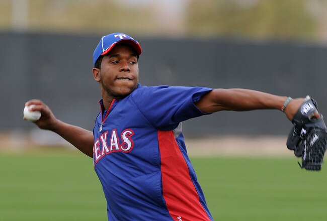 SURPRISE, AZ - FEBRUARY 18:  Neftali Feliz #30 of the Texas Rangers warms up prior to spring workouts at Surprise Stadium on February 18, 2011 in Surprise, Arizona.  (Photo by Norm Hall/Getty Images)