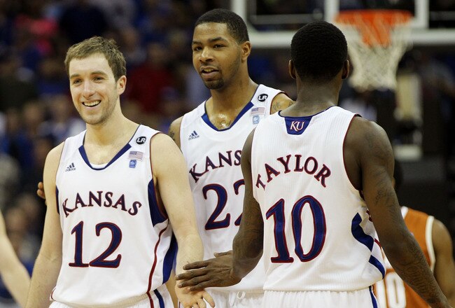 KANSAS CITY, MO - MARCH 12:  Brady Morningstar #12, Marcus Morris #22 and Tyshawn Taylor #10 of the Kansas Jayhawks react after a play against the Texas Longhorns during the 2011 Phillips 66 Big 12 Men's Basketball Tournament championship game at Sprint Center on March 12, 2011 in Kansas City, Missouri.  (Photo by Jamie Squire/Getty Images)