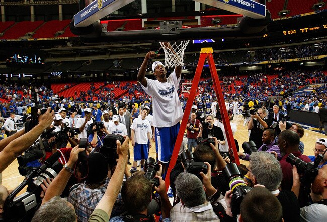 ATLANTA - MARCH 13: Deandre Liggins #34 of the Kentucky Wildcats cuts down the net after their 70 to 54 win over the Florida Gators in the championship game of the SEC Men's Basketball Tournament at Georgia Dome on March 13, 2011 in Atlanta, Georgia. (Photo by Kevin C. Cox/Getty Images)