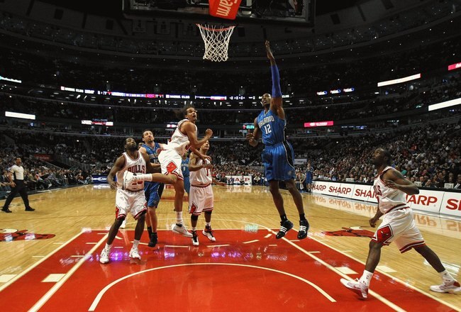 CHICAGO - FEBRUARY 24: Dwight Howard #12 of the Orlando Magic attempts a shot against Joakim Noah #13 of the Chicago Bulls at the United Center on Feberuary 24, 2009 in Chicago, Illinois.  NOTE TO USER: User expressly acknowledges and agreees that, by downloading and/or using this Photograph, User is consenting to the terms and conditions of the Getty Images License Agreement.  (Photo by Jonathan Daniel/Getty Images)