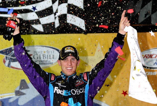 RICHMOND, VA - SEPTEMBER 11:  Denny Hamlin, driver of the #11 FedEx Office Toyota, celebrates in Victory Lane after winning the NASCAR Sprint Cup Series Air Guard 400 at Richmond International Raceway on September 11, 2010 in Richmond, Virginia.  (Photo by John Harrelson/Getty Images for NASCAR)