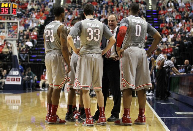 INDIANAPOLIS, IN - MARCH 13:  Head coach Thad Matta of the Ohio State Buckeyes talks with his players during a timeout including David Lighty #23, Jon Diebler #33 and Jared Sullinger #0 against the Penn State Nittany Lions during the championship game of the 2011 Big Ten Men's Basketball Tournament at Conseco Fieldhouse on March 13, 2011 in Indianapolis, Indiana. Ohio State won 71-60. (Photo by Andy Lyons/Getty Images)