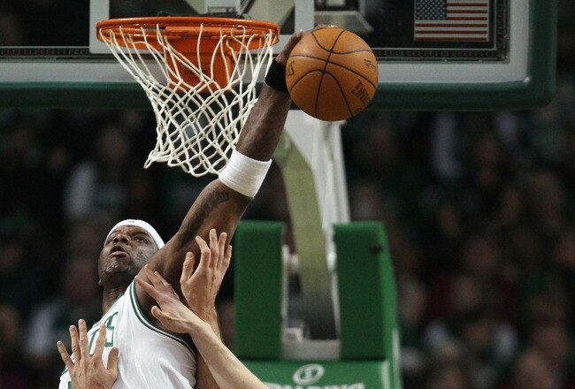 BOSTON, MA - JANUARY 07:  Jermaine O'Neal #7 of the Boston Celtics blocks a shot by Linas Kleiza #11  of the Toronto Raptors as Luke Harangody #55 of the Celtics fouls on January 7, 2011 at the TD Garden in Boston, Massachusetts. NOTE TO USER: User expressly acknowledges and agrees that, by downloading and/or using this Photograph, User is consenting to the terms and conditions of the Getty Images License Agreement.  (Photo by Elsa/Getty Images)