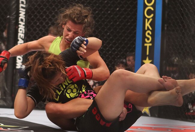 PHOENIX - AUGUST 13:  Miesha Tate (L) battles with Hitomi Akano of Japan in the Strikeforce Women's Welterweight Tournament Championship bout at Dodge Theater on August 13, 2010 in Phoenix, Arizona.  (Photo by Christian Petersen/Getty Images)