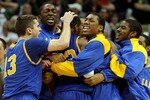 DENVER, CO - MARCH 17:  Demonte Harper #22 of the Morehead State Eagles is mobbed by his teammates after hitting a game winning three point shot with 5.5 seconds left on the clock against the Louisville Cardinals during the second round of the 2011 NCAA men's basketball tournament at Pepsi Center on March 17, 2011 in Denver, Colorado. The Morehead State Eagles defeated the Louisville Cardinals by a score of 62-61.  (Photo by Justin Edmonds/Getty Images)