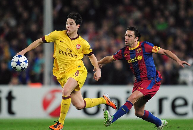 BARCELONA, SPAIN - MARCH 08:   Samir Nasri (L) of Arsenal is challenged by Xavi Hernandez of Barcelona during the UEFA Champions League round of 16 second leg match between Barcelona and Arsenal at the Nou Camp Stadium on March 8, 2011 in Barcelona, Spain.  (Photo by Shaun Botterill/Getty Images)