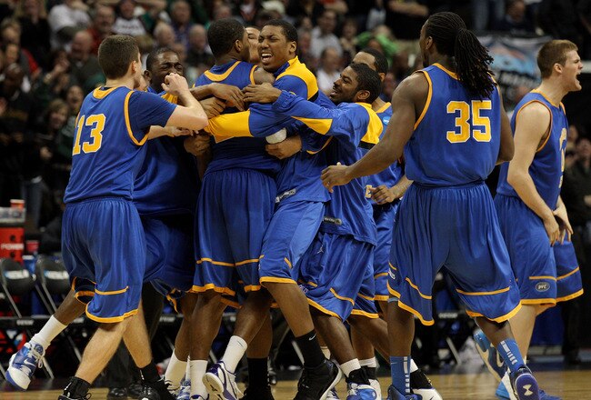 DENVER, CO - MARCH 17:  Demonte Harper #22 of the Morehead State Eagles is mobbed by his teammates after hitting a game winning three point shot with 5.5 seconds left on the clock against the Louisville Cardinals during the second round of the 2011 NCAA men's basketball tournament at Pepsi Center on March 17, 2011 in Denver, Colorado. The Morehead State Eagles defeated the Louisville Cardinals by a score of 62-61.  (Photo by Justin Edmonds/Getty Images)