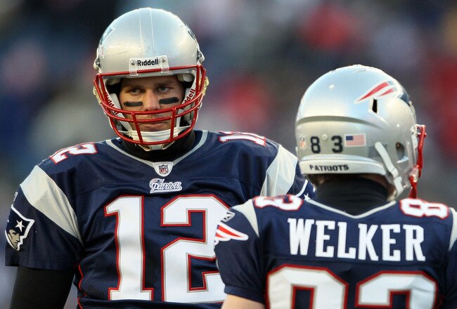 FOXBORO, MA - JANUARY 16:  Tom Brady #12 and Wes Welker #83 of the New England Patriots look on during their 2011 AFC divisional playoff game against the New York Jets at Gillette Stadium on January 16, 2011 in Foxboro, Massachusetts.  (Photo by Elsa/Getty Images)