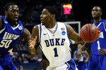 CHARLOTTE, NC - MARCH 18:  Kyrie Irving #1 of the Duke Blue Devils drives on Milade Lola-Charles #50 of the Hampton Pirates in the first half during the second round of the 2011 NCAA men's basketball tournament at Time Warner Cable Arena on March 18, 2011 in Charlotte, North Carolina.  (Photo by Kevin C. Cox/Getty Images)