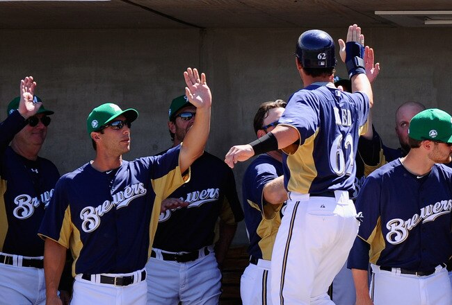PHOENIX, AZ - MARCH 17:  Jeremy Reed #62 of the Milwaukee Brewers is congratulated by teammates after scoring a run on a base hit by Edwin Maysonet #68 against pitcher Edwin Jackson #33 of the Chicago White Sox during the first inning of the spring training game at Maryvale Baseball Park on March 17, 2011 in Phoenix, Arizona.  (Photo by Kevork Djansezian/Getty Images)