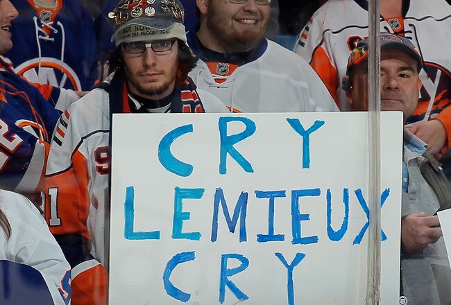 UNIONDALE, NY - FEBRUARY 17:  Fans hold a sign in reference to Mario Lemieux statements regarding a fight between the Islanders and Pittsburgh Penguins before an NHL hockey game between the New York Islanders and the Boston Bruins at the Nassau Coliseum on February 17, 2011 in Uniondale, New York.  (Photo by Paul Bereswill/Getty Images)