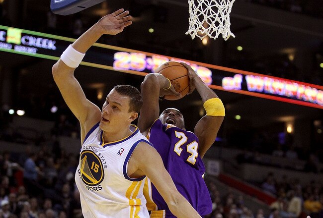 OAKLAND, CA - JANUARY 12: Kobe Bryant #24 of the Los Angeles Lakers is fouled by Andris Biedrins #15 of the Golden State Warriors at Oracle Arena on January 12, 2011 in Oakland, California. NOTE TO USER: User expressly acknowledges and agrees that, by downloading and or using this photograph, User is consenting to the terms and conditions of the Getty Images License Agreement. (Photo by Ezra Shaw/Getty Images)