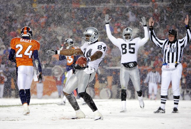 DENVER - NOVEMBER 28:  Wide receiver Jerry Porter #84 of the Oakland Raiders celebrates one of his two touchdowns against the Denver Broncos on November 28, 2004 at Invesco Field at Mile High Stadium in Denver, Colorado.  The Raiders won 25-24.  (Photo by Brian Bahr/Getty Images)