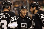 LOS ANGELES, CA - MARCH 03:  Trevor Lewis #22 of the Los Angeles Kings talks to teammates Jarret Stoll #28 and Willie Mitchell #33 prior to a defensive zone faceoff during the NHL game against the Phoenix Coyotes at Staples Center on March 3, 2011 in Los Angeles, California. The Kings defeated the Coyotes 1-0.  (Photo by Victor Decolongon/Getty Images)