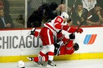 CHICAGO - MAY 22:  Martin Havlat #24 of the Chicago Blackhawks checked hard to the ice by Niklas Kronwall #55 of the Detroit Red Wings during the first period of Game Three of the Western Conference Championship Round of the 2009 Stanley Cup Playoffs on May 22, 2009 at the United Center in Chicago, Illinois.  (Photo by Jim Prisching/Getty Images)