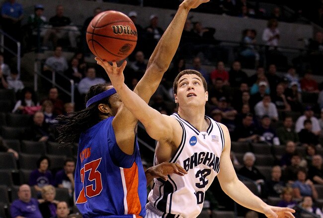 OKLAHOMA CITY - MARCH 18:  Jimmer Fredette #32 of the BYU Cougars drives for a shot attempt against Alex Tyus #23 of the Florida Gators during the first round of the 2010 NCAA men�s basketball tournament at Ford Center on March 18, 2010 in Oklahoma City, Oklahoma.  (Photo by Ronald Martinez/Getty Images)