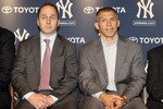NEW YORK, NY - JANUARY 19:  General manager Brian Cashman (L) and manager Joe Girardi of the New York Yankees listen as Rafael Soriano (not pictured) speaks during his introduction press conference on January 19, 2011 at Yankee Stadium in the Bronx borough of New York City. The Yankees signed Soriano to a three-year contract.  (Photo by Jim McIsaac/Getty Images)