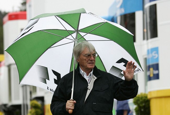 SPA FRANCORCHAMPS, BELGIUM - AUGUST 28: Bernie Ecclestone walks down the paddock as it rains during the practice session prior to qualifying for the Belgium F1 Grand Prix at the Circuit of Spa Francorchamps on August 28, 2004, in Spa Francorchamps, Belgium. (Photo by Paul Gilham/Getty Images)