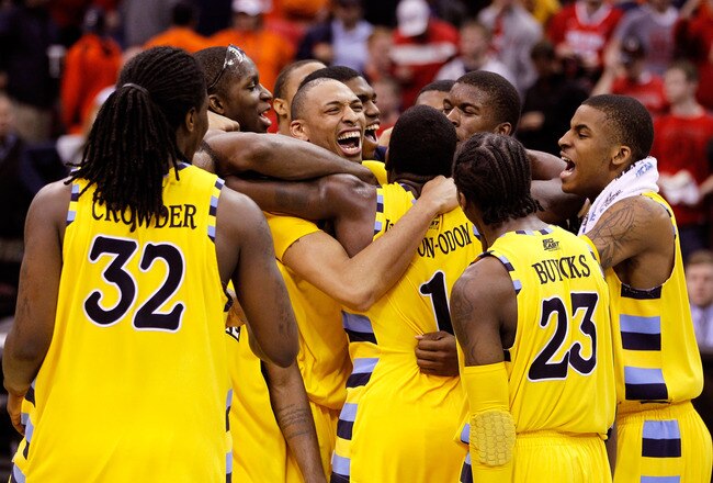 CLEVELAND, OH - MARCH 20: Jae Crowder #32, Joseph Fulce #21, Darius Johnson-Odom #1 and Dwight Buycks #23 of the Marquette Golden Eagles celebrate with teammates after defeating the Syracuse Orange during the third of the 2011 NCAA men's basketball tournament at Quicken Loans Arena on March 20, 2011 in Cleveland, Ohio.  (Photo by Gregory Shamus/Getty Images)