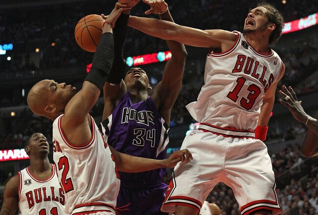CHICAGO, IL - MARCH 21: Joakim Noah #13 of the Chicago Bulls blocks a shot by Jason Thompson #34 of the Sacramento Kings as teammate Taj Gibson #22 also defends at the United Center on March 21, 2011 in Chicago, Illinois. NOTE TO USER: User expressly acknowledges and agrees that, by downloading and/or using this photograph, User is consenting to the terms and conditions of the Getty Images License Agreement. (Photo by Jonathan Daniel/Getty Images)