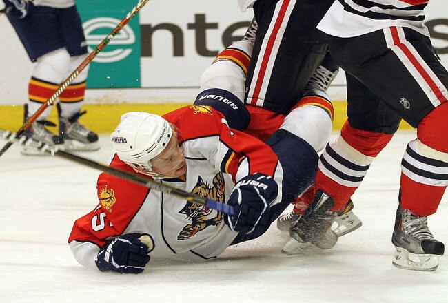 CHICAGO, IL - MARCH 23:  Brian Campbell #51 of the Chicago Blackhawks hits Jack Skille #15 of the Florida Panthers at the United Center on March 23, 2011 in Chicago, Illinois.  (Photo by Bruce Bennett/Getty Images)
