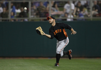 GLENDALE, AZ - MARCH 04:  Outfielder Cody Ross #13 of the San Francisco Giants catches a fly ball out against the Los Angeles Dodgers during the spring training game at Camelback Ranch on March 4, 2011 in Glendale, Arizona.  (Photo by Christian Petersen/Getty Images)