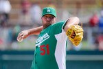 GLENDALE, AZ - MARCH 17:  Pitcher Jonathan Broxton #51 of the Los Angeles Dodgers wearing a green jersey in celebration of St. Patrick's Day throws a pitch against the Arizona Diamondbacks during the spring training baseball game on March 17, 2011 in Glendale, Arizona.  (Photo by Kevork Djansezian/Getty Images)