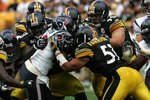 PITTSBURGH - SEPTEMBER 07:  Running back Steve Slaton #20 of the Houston Texans is tackled by Nick Eason #93, Lawrence Timmons #94, James Harrison #92, Travis Kirschke #90 and James Farrior #51 of the Pittsburgh Steelers on September 7, 2008 at Heinz Field in Pittsburgh, Pennsylvania.  (Photo by Ronald Martinez/Getty Images)