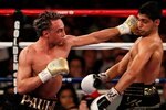 NEW YORK - MAY 15:   Paulie Malignaggi (L) hits Amir Khan of Great Britain during the WBA light welterweight title fight at Madison Square Garden on May 15, 2010 in New York City.  (Photo by Chris Trotman/Getty Images)