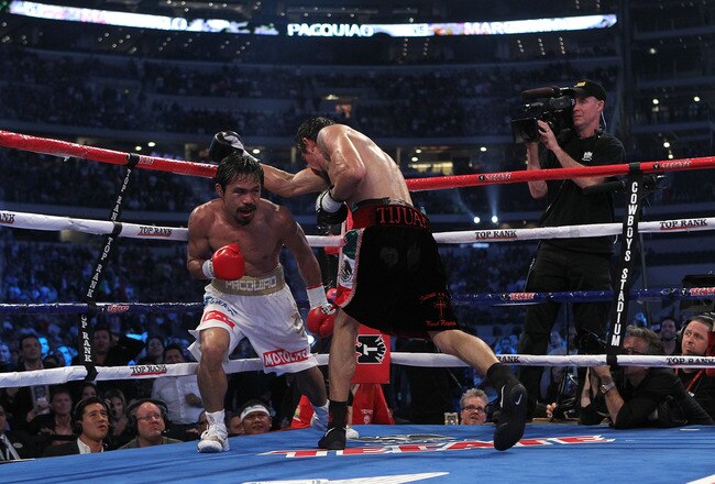 ARLINGTON, TX - NOVEMBER 13:  Manny Pacquiao (white trunks) of the Philippines fights against Antonio Margarito (black trunks) of Mexico during their WBC World Super Welterweight Title bout at Cowboys Stadium on November 13, 2010 in Arlington, Texas.  (Photo by Nick Laham/Getty Images)