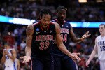 ANAHEIM, CA - MARCH 24:  Jesse Perry #33 and Solomon Hill #44 of the Arizona Wildcats react after a play against the Duke Blue Devils during the west regional semifinal of the 2011 NCAA men's basketball tournament at the Honda Center on March 24, 2011 in Anaheim, California.  (Photo by Harry How/Getty Images)
