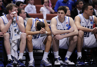 ANAHEIM, CA - MARCH 24:  Kyle Singler #12, Seth Curry #30, Ryan Kelly #34 and Miles Plumlee #21 of the Duke Blue Devils look on from the bench against the Arizona Wildcats during the west regional semifinal of the 2011 NCAA men's basketball tournament at the Honda Center on March 24, 2011 in Anaheim, California.  (Photo by Harry How/Getty Images)