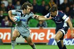 MELBOURNE, AUSTRALIA - MARCH 25:  Conrad Smith of the Hurricanes fends off JP du Plessis of the Rebels during the round six Super Rugby match between the Melbourne Rebels and the Hurricanes on March 25, 2011 in Melbourne, Australia.  (Photo by Mark Dadswell/Getty Images)