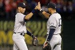 ARLINGTON, TX - OCTOBER 15:  (L-R) Derek Jeter #2 and Alex Rodriguez #13 of the New York Yankees celebrate after the Yankees won 6-5 against the Texas Rangers in Game One of the ALCS during the 2010 MLB Playoffs at Rangers Ballpark in Arlington on October 15, 2010 in Arlington, Texas.  (Photo by Ronald Martinez/Getty Images)