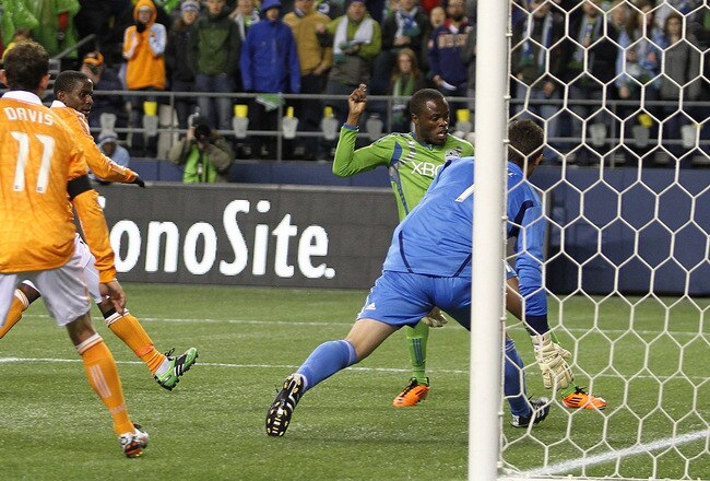 SEATTLE - MARCH 25:  Steve Zakuani #11 of the Seattle Sounders FC scores a goal against goalkeeper Tally Hall #1 of the Houston Dynamo at Qwest Field on March 25, 2011 in Seattle, Washington. (Photo by Otto Greule Jr/Getty Images)