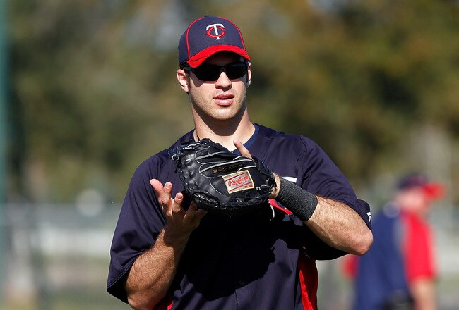 FORT MYERS, FL - FEBRUARY 23:  Catcher Joe Mauer #7 of the Minnesota Twins warms up during a spring training workout session at Hammond Stadium on February 23, 2011 in Fort Myers, Florida.  (Photo by J. Meric/Getty Images)