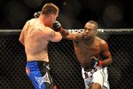 LAS VEGAS - JULY 11:  (R-L) Jon Jones connects with a right punch on Jake O'Brein during their light heavyweight bout during UFC 100 on July 11, 2009 in Las Vegas, Nevada. Jones defeated O'Brein by second round tapout.  (Photo by Jon Kopaloff/Getty Images)