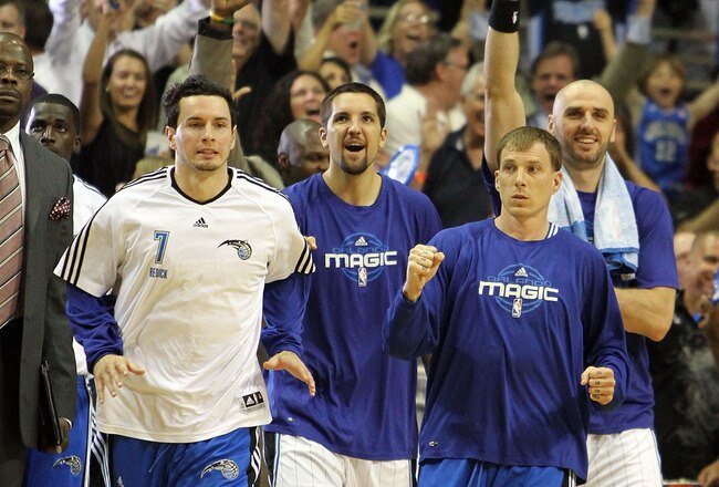 ORLANDO, FL - MAY 06:  J.J. Redick #7, Ryan Anderson #33, Jason Williams #44 and Marcin Gortat #13 of the Orlando Magic celebrate after Jameer Nelson #14 hits a desperation three-point basket with less than a second left in the third quarter to give the Magic the lead against the Atlanta Hawks in Game Two of the Eastern Conference Semifinals during the 2010 NBA Playoffs at Amway Arena on May 6, 2010 in Orlando, Florida. The Magic defeated the Hawks 112-98. NOTE TO USER: User expressly acknowledges and agrees that, by downloading and/or using this Photograph, user is consenting to the terms and conditions of the Getty Images License Agreement.  (Photo by Doug Benc/Getty Images)