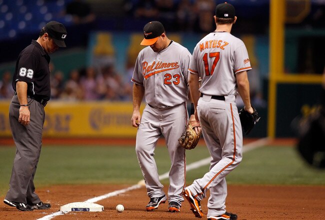 ST. PETERSBURG - SEPTEMBER 27:  Ty Wigginton #23 of the Baltimore Orioles watches a bunt in hopes that it would roll foul with pitcher Brian Matusz #17 looking on against the Tampa Bay Rays during the game at Tropicana Field on September 27, 2010 in St. Petersburg, Florida.  (Photo by J. Meric/Getty Images)