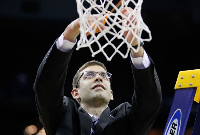 NEW ORLEANS, LA - MARCH 26:  Head coach Brad Stevens of the Butler Bulldogs celebrates defeateing the Florida Gators 74 to 71 in overtime by cuttin down part of the net during the Southeast regional final of the 2011 NCAA men's basketball tournament at New Orleans Arena on March 26, 2011 in New Orleans, Louisiana.  (Photo by Kevin C. Cox/Getty Images)