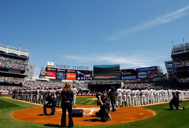 NEW YORK - APRIL 16: Recording artist Kelly Clarkson sings the National Anthem before the opening day game between the Cleveland Indians and the New York Yankees at the new Yankee Stadium on April 16, 2009 in the Bronx borough of New York City. This is the first regular season MLB game being played at the new venue which replaced the old Yankee Stadium as the Yankees home field.  (Photo by Jim McIsaac/Getty Images)