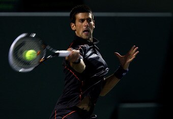 KEY BISCAYNE, FL - MARCH 30: Novak Djokovic of Serbia hits a return against Kevin Anderson of South Africa during the Sony Ericsson Open at Crandon Park Tennis Center on March 30, 2011 in Key Biscayne, Florida. (Photo by Clive Brunskill/Getty Images)