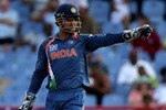 GROS ISLET, SAINT LUCIA - MAY 11:  M S Dhoni of Indiasets a field during the ICC Super Eight match between India and Sri Lanka played at the Beausejour Cricket Ground on May 11, 2010 in Gros Islet, Saint Lucia.  (Photo by Julian Herbert/Getty Images)