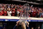 PHILADELPHIA - OCTOBER 29:  The World Series Championship trophy is held up in front of fans of the Philadelphia Phillies after they won 4-3 against the Tampa Bay Rays during the continuation of game five of the 2008 MLB World Series on October 29, 2008 at Citizens Bank Park in Philadelphia, Pennsylvania.  (Photo by Jed Jacobsohn/Getty Images)