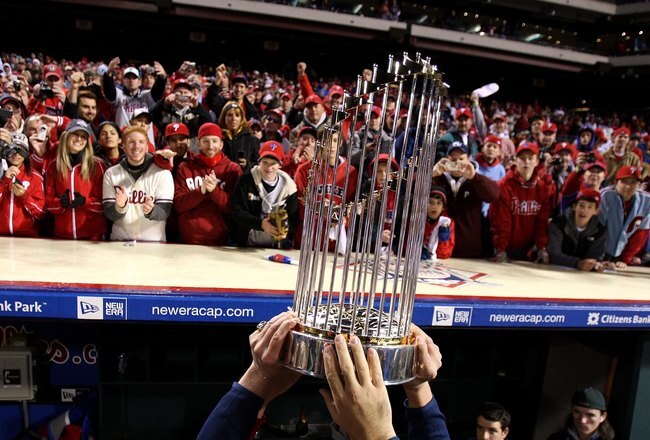 PHILADELPHIA - OCTOBER 29:  The World Series Championship trophy is held up in front of fans of the Philadelphia Phillies after they won 4-3 against the Tampa Bay Rays during the continuation of game five of the 2008 MLB World Series on October 29, 2008 at Citizens Bank Park in Philadelphia, Pennsylvania.  (Photo by Jed Jacobsohn/Getty Images)