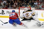 MONTREAL, CANADA - JANUARY 8:  Tim Thomas #30 of the Boston Bruins stretches out to stop the puck in front of Jeff Halpern #15 of the Montreal Canadiens during the NHL game at the Bell Centre on January 8, 2011 in Montreal, Quebec, Canada.  (Photo by Richard Wolowicz/Getty Images)