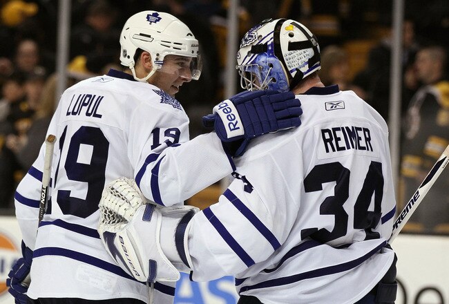 BOSTON, MA - MARCH 31:  James Reimer #34 of the Toronto Maple Leafs is congratulated by teammate Joffrey Lupul #19 after the game against the Boston Bruins on March 31, 2011 at the TD Garden in Boston, Massachusetts. The Toronto Maple Leafs defeated the Boston Bruins 4-3 in an overtime shootout.  (Photo by Elsa/Getty Images)