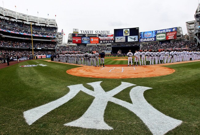 NEW YORK, NY - MARCH 31:  The New York Yankees and the Detroit Tigers look on as West Point Cadets unfurl the American Flag during the opening ceremonies on Opening Day at Yankee Stadium on March 31, 2011 in Bronx borough of New York City.  (Photo by Nick Laham/Getty Images)