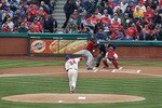 PHILADELPHIA, PA - APRIL 01:  Starting pitcher Roy Halladay #34 of the Philadelphia Phillies delivers the first pitch of opening day to batter Michael Bourn #21 of the Houston Astros as catcher Carlos Ruiz #51 of the Philadelphia Phillies and home plate umpire  Jerry Layne wait for the pitch at Citizens Bank Park on April 1, 2011 in Philadelphia, Pennsylvania.
